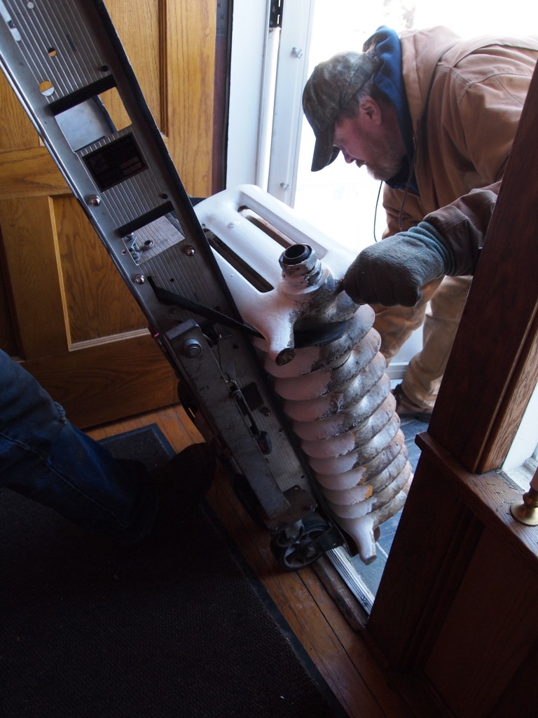 Radiator on a dolly with an extra set of wheels so it can go up and down stairs