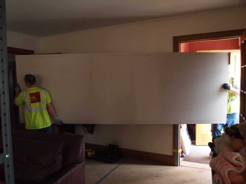12 ft. long sheetrock panels being loaded into the house.
