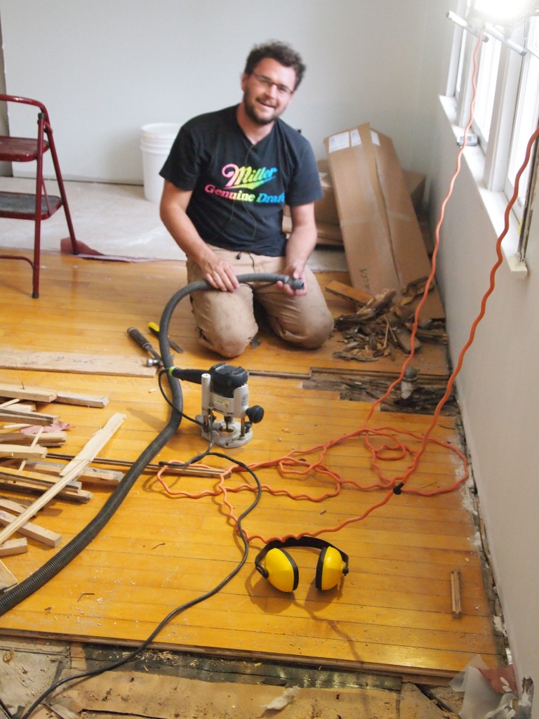 When a radiator valve leaks the wood floor can rot away. Chris is clearing out the old wood and preparing to weave in the wood from Habitat's ReStore.