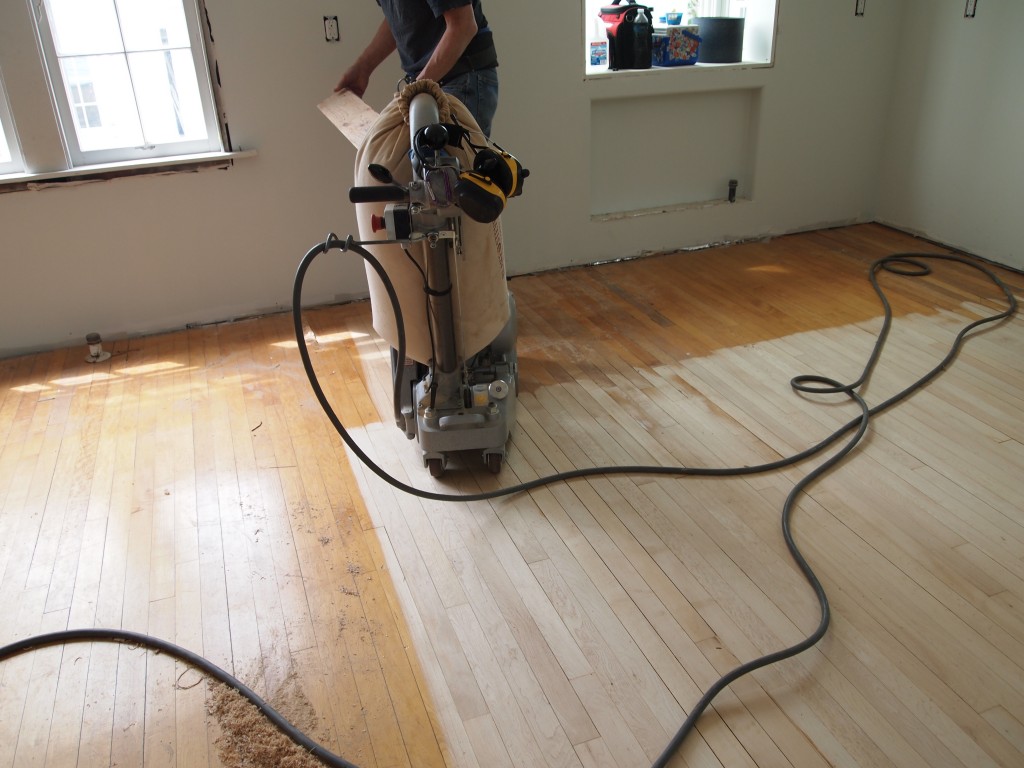 Sanding the old maple floor. The "old" maple pieces from the ReStore were weaved into the existing floor. It is hard to tell the "old" old from the "new" old.
