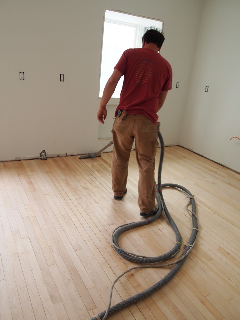 After he sanded the floor, Chris vacuumed it then used a "tack" mop to get all of the dust.