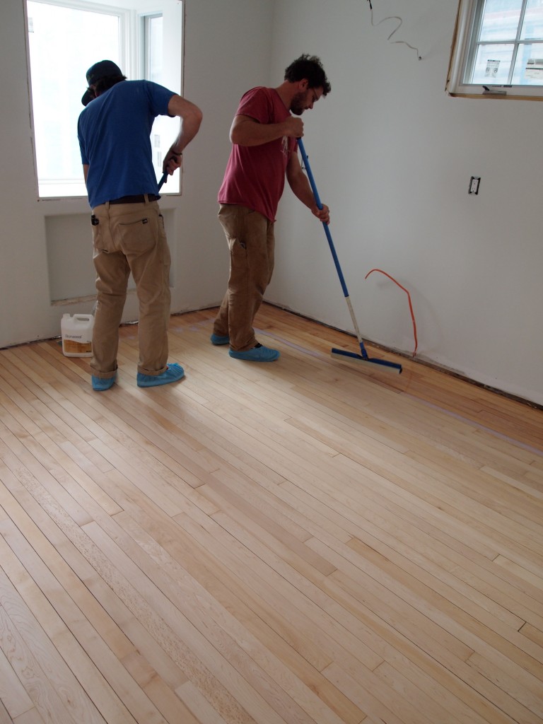 Jason and Chris start in a corner to apply the sealer. Jason works the sealer around the perimeter and Chris works from the perimeter to the center. Their process was like choreography.