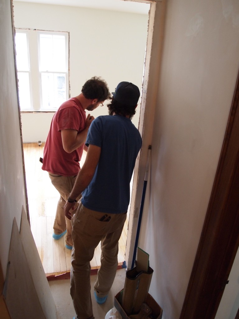 Chris and Jason finish the second of three coats on the kitchen floor.