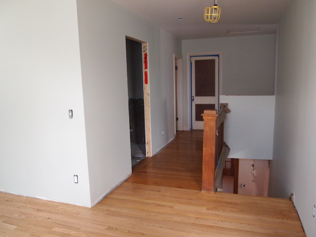 The old and new oak meet at the upstairs hallway. The old oak has a polyurethane finish that has yellowed with age. The new floor has a water based image and its color will not change much with age.