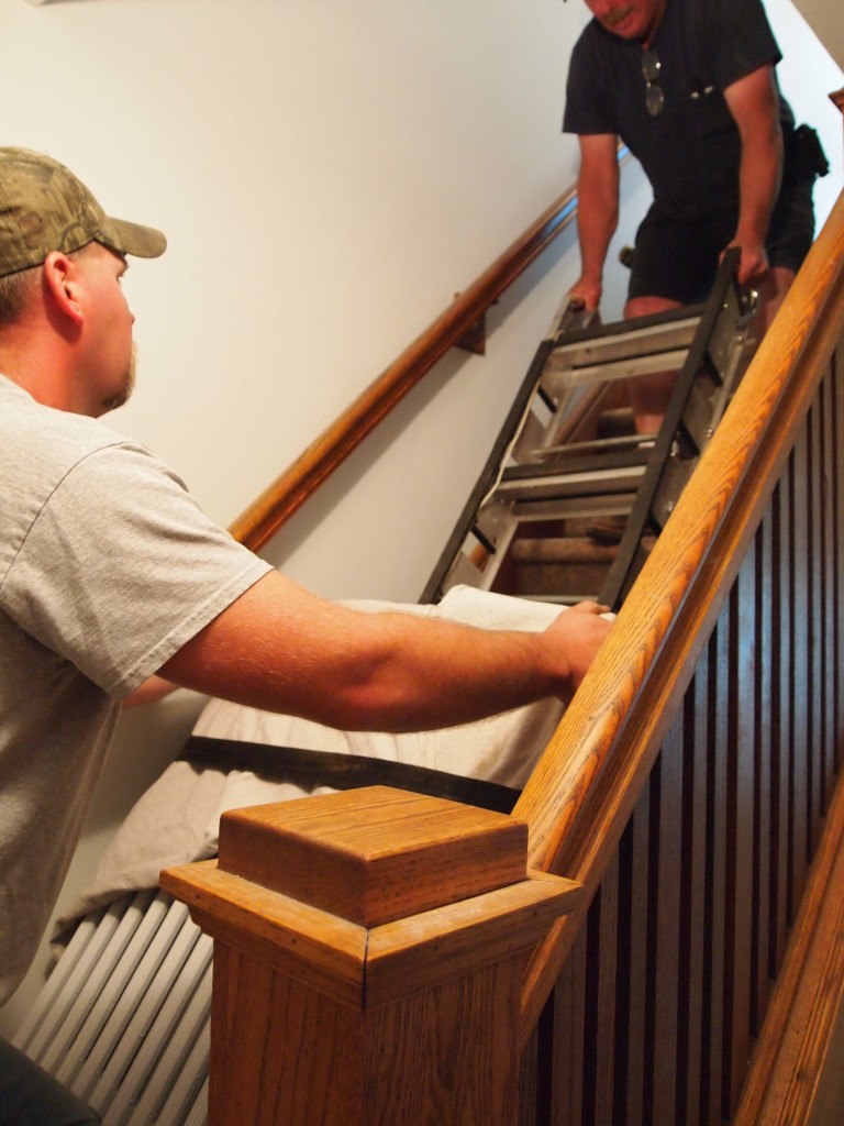 Bringing one of two radiators upstairs.