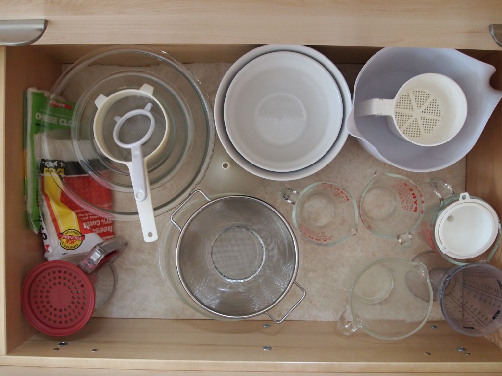 Mixing bowls and measuring cups get their own drawer.