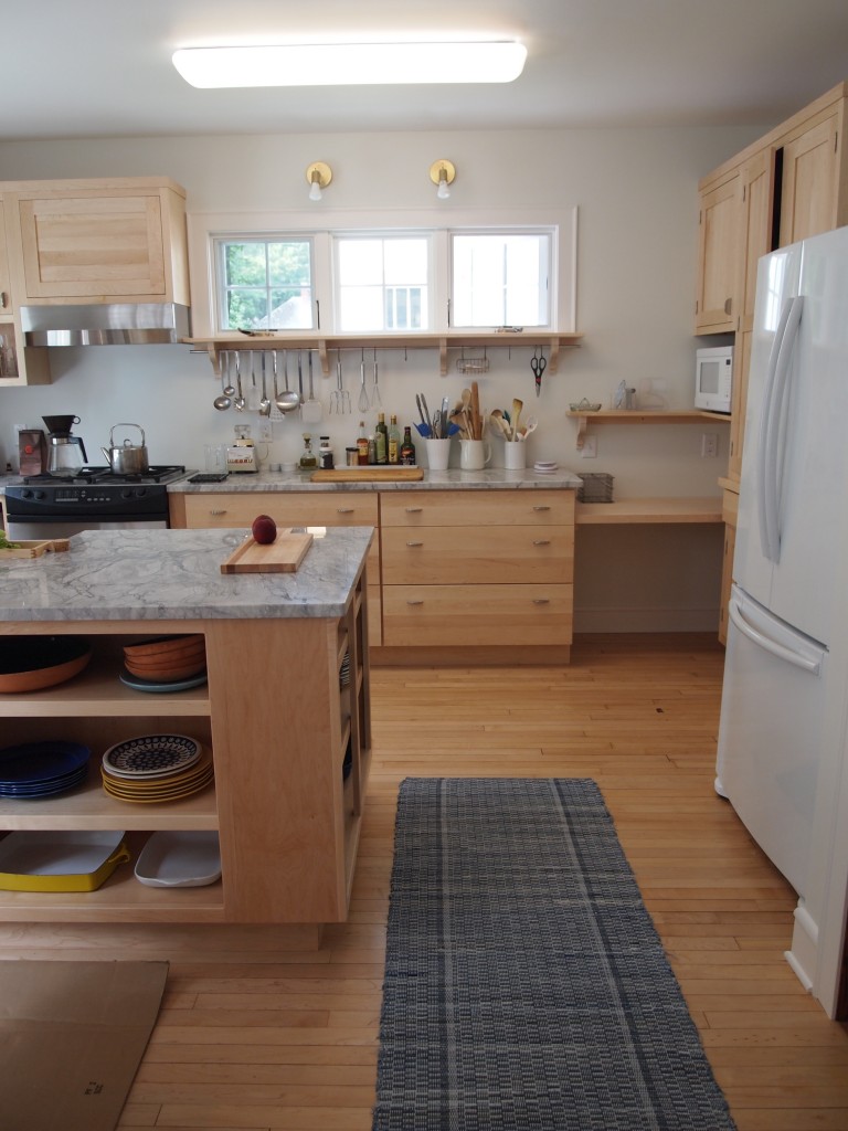 Butcher block is in, baseboards are painted and the floor sports a denim rag rug.